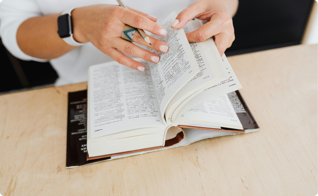 A person flicking through the pages of a dictionary.